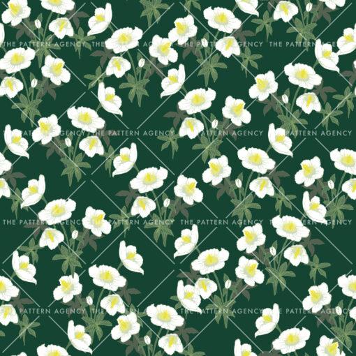 A seamless pattern with white Christmas rose flowers on a green background. The detailed flowers with their soft petals and yellow stamens create an elegant and sophisticated feel